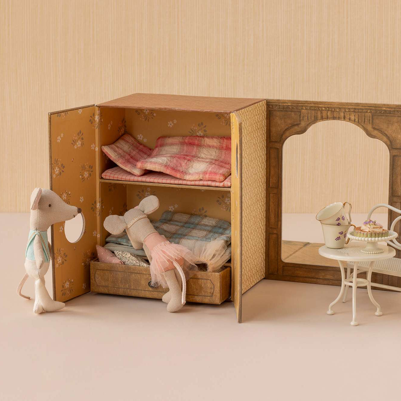 Miniature Maileg ballet studio dollhouse with furniture and plush toys on a neutral background