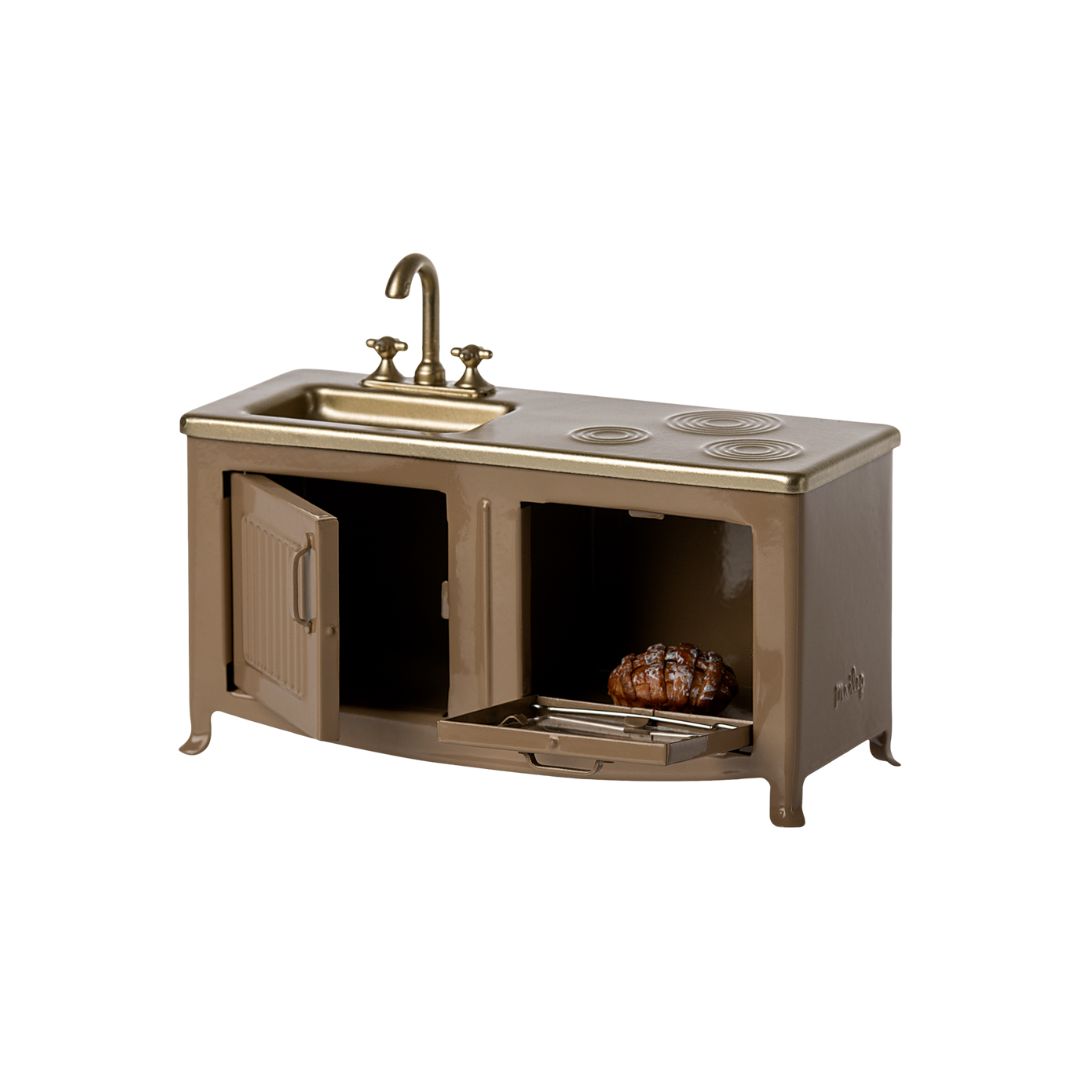 Maileg brown kitchen for a Maileg dollshouse collection with Maileg sink, open cupboard door, and oven with a bun