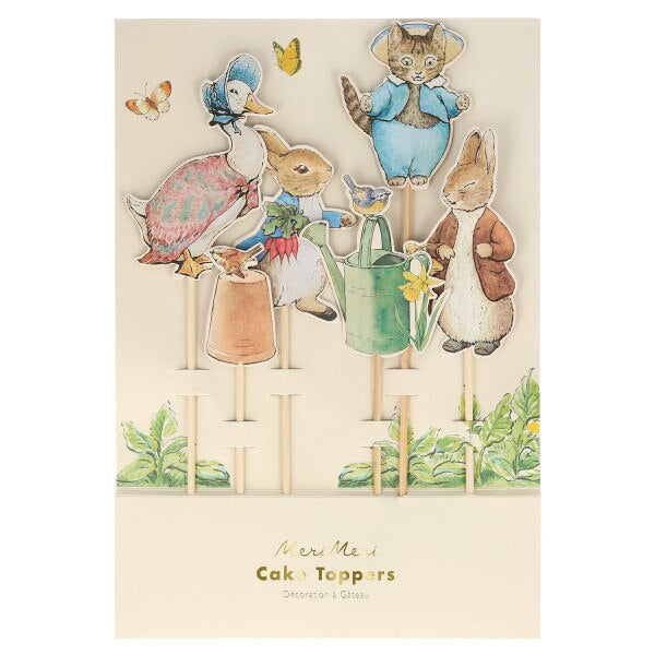 Cake toppers with illustrated Peter Rabbit characters and garden elements on a beige background. Official Peter Rabbit party decoration cake toppers by Meri Meri at Mouse in a Box