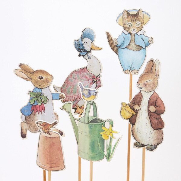 Set of paper dolls featuring a Peter Rabbit, Jemima Puddleduck, Tom Kitten, and other Peter Rabbit animal characters on sticks with a white background. Peter Rabbit party cake toppers from Meri Meri at Mouse in a Box