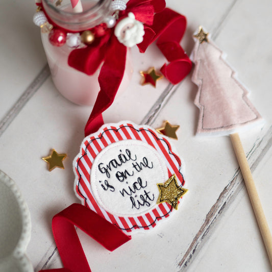 Childrens personalised name badge with name is on the nice list, Christmas nice list badge with red stripes hand embroidered by Girl Friday Embroidery at Mouse in a Box