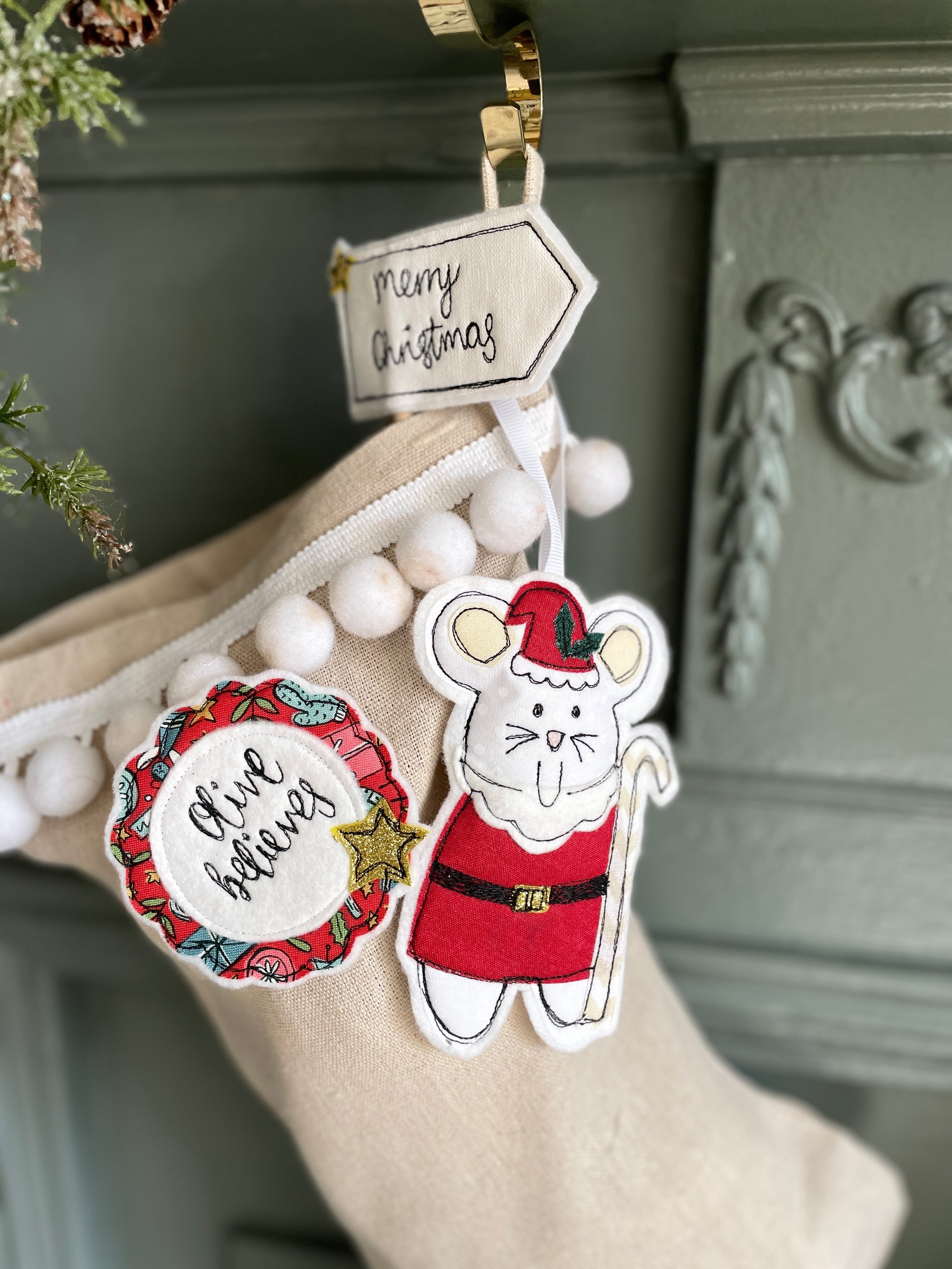 Decorative Christmas tags with a mouse in Santa Claus outfit and wreath design on a stocking.